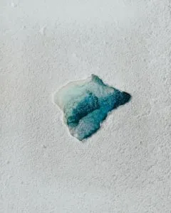 white and blue stone on white sand