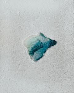 white and blue stone on white sand